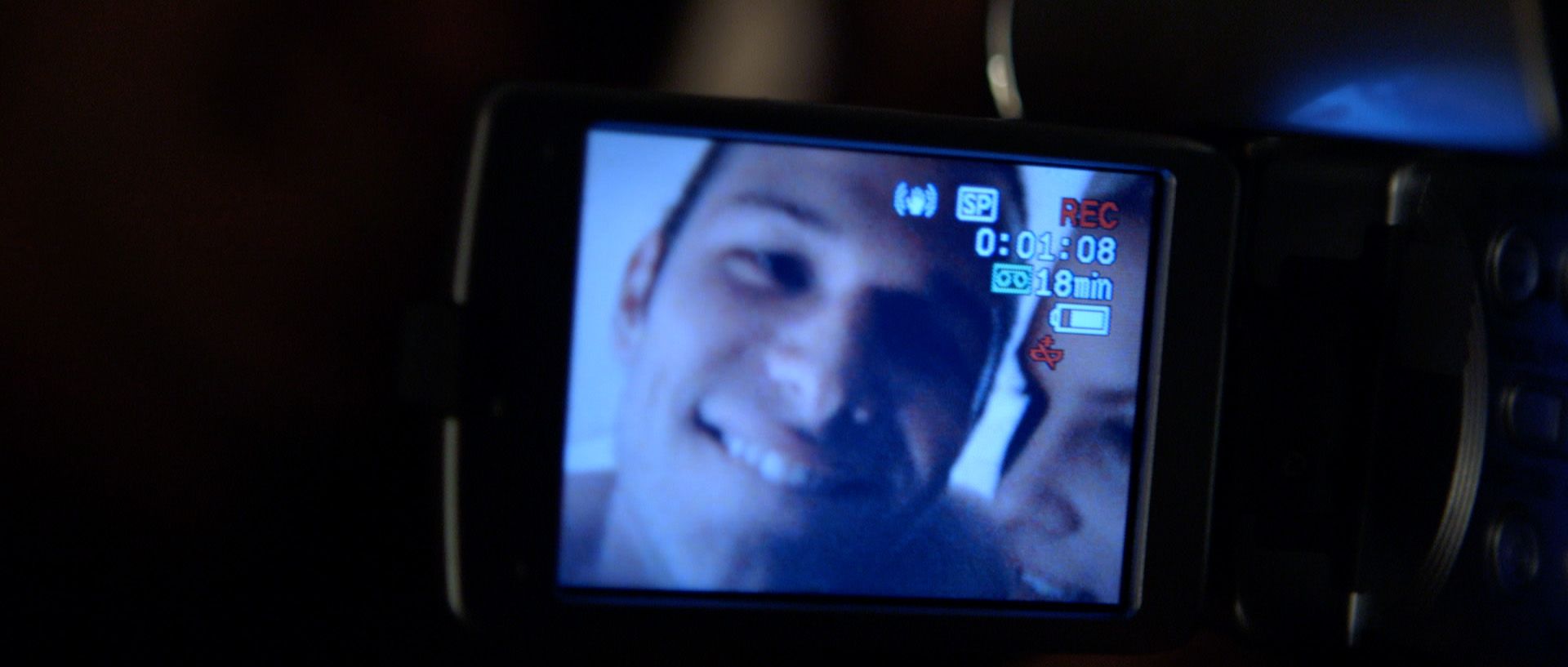 A still of a video camera screen recording JJ and Sammy.